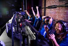 A group of eSports player cheer after winning a game. 